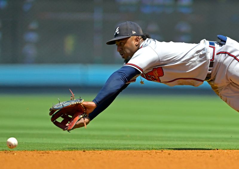 Sep 3, 2023; Los Angeles, California, USA;  Los Angeles Dodgers catcher Will Smith (16) singles past Atlanta Braves second baseman Ozzie Albies (1) in the first inning at Dodger Stadium. Mandatory Credit: Jayne Kamin-Oncea-USA TODAY Sports