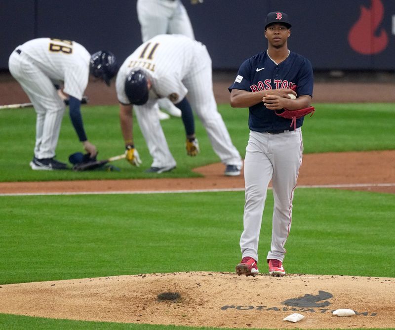 Apr 23, 2023; Milwaukee, Wisconsin, USA; Boston Red Sox starting pitcher Brayan Bello (66) turns around after walking Milwaukee Brewers first baseman Rowdy Tellez (11) during the first inning at American Family Field. Mandatory Credit: Mark Hoffman-USA TODAY Sports