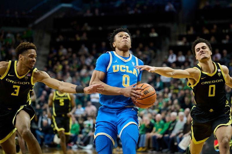 Feb 11, 2023; Eugene, Oregon, USA;  UCLA Bruins guard Jaylen Clark (0) drives to the basket during the second half against Oregon Ducks guard Keeshawn Barthelemy (3) and guard Will Richardson (0) at Matthew Knight Arena. Mandatory Credit: Troy Wayrynen-USA TODAY Sports