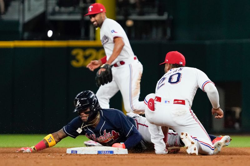 May 17, 2023; Arlington, Texas, USA; Atlanta Braves right fielder Ronald Acuna Jr. (13) slides in safely with a stolen base as Texas Rangers shortstop Ezequiel Duran (20) cannot handle the throw during the eighth inning at Globe Life Field. Mandatory Credit: Raymond Carlin III-USA TODAY Sports