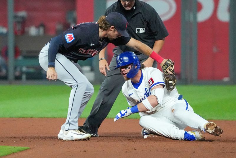 Sep 4, 2024; Kansas City, Missouri, USA;  Cleveland Guardians shortstop Daniel Schneemann (10) misses the tag as Kansas City Royals shortstop Bobby Witt Jr. (7) reaches second base on a double in the seventh inning at Kauffman Stadium. Mandatory Credit: Denny Medley-Imagn Images