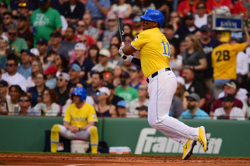 May 3, 2025; Boston, Massachusetts, USA;  Boston Red Sox designated hitter Rafael Devers (11) hits an RBI single during the third inning against the Minnesota Twins at Fenway Park. Mandatory Credit: Bob DeChiara-Imagn Images