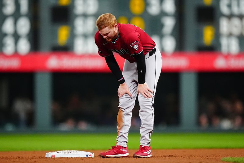 Sep 17, 2024; Denver, Colorado, USA; Arizona Diamondbacks left fielder Pavin Smith (26) after sliding into a double play in the sixth inning at Coors Field. Mandatory Credit: Ron Chenoy-Imagn Images