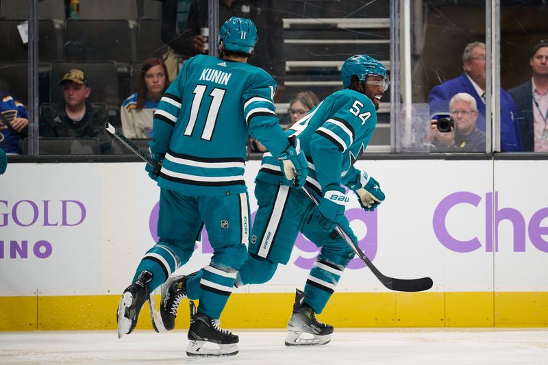 Nov 16, 2023; San Jose, California, USA; San Jose Sharks right wing Givani Smith (54) skates to the bench with center Luke Kunin (11) after scoring a goal against the St. Louis Blues during the second period at SAP Center at San Jose. Mandatory Credit: Robert Edwards-USA TODAY Sports