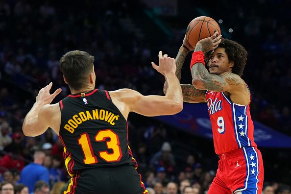 PHILADELPHIA, PENNSYLVANIA - DECEMBER 8: Kelly Oubre Jr. #9 of the Philadelphia 76ers shoots the ball against Bogdan Bogdanovic #13 of the Atlanta Hawks in the second quarter at the Wells Fargo Center on December 8, 2023 in Philadelphia, Pennsylvania. The 76ers defeated the Hawks 125-114. NOTE TO USER: User expressly acknowledges and agrees that, by downloading and or using this photograph, User is consenting to the terms and conditions of the Getty Images License Agreement. (Photo by Mitchell Leff/Getty Images)