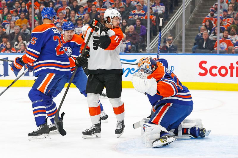 Jan 2, 2024; Edmonton, Alberta, CAN; Philadelphia Flyers forward Bobby Brink (10) looks for a loose puck in front of Edmonton Oilers goaltender Stuart Skinner (74) during the second period at Rogers Place. Mandatory Credit: Perry Nelson-USA TODAY Sports