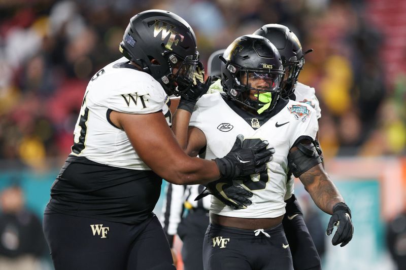 Dec 23, 2022; Tampa, Florida, USA; Wake Forest Demon Deacons running back Justice Ellison (6) is congratulated after scoring a touchdown against the Missouri Tigers in the second quarter in the 2022 Gasparilla Bowl at Raymond James Stadium. Mandatory Credit: Nathan Ray Seebeck-USA TODAY Sports