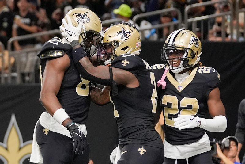 New Orleans Saints running back Jamaal Williams, center, celebrates a touchdown with tight end Juwan Johnson, left, and wide receiver Rashid Shaheed (22) during the second half of an NFL football game against the Carolina Panthers, Sunday, Sept. 8, 2024, in New Orleans. (AP Photo/Gerald Herbert)