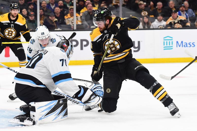 Nov 21, 2024; Boston, Massachusetts, USA;  Boston Bruins right wing Justin Brazeau (55) tries to get control of the puck in front of Utah Hockey Club goaltender Karel Vejmelka (70) during the first period at TD Garden. Mandatory Credit: Bob DeChiara-Imagn Images