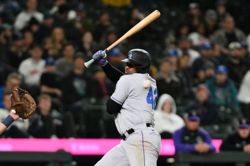 Apr 15, 2023; Seattle, Washington, USA; Colorado Rockies third baseman Elehuris Montero is hit by a pitch thrown by Seattle Mariners relief pitcher Diego Castillo (not pictured) during the ninth inning at T-Mobile Park. Mandatory Credit: Steven Bisig-USA TODAY Sports