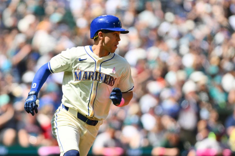 May 12, 2024; Seattle, Washington, USA; Seattle Mariners left fielder Sam Haggerty (0) runs towards first base after hitting an RBI single against the Oakland Athletics during the second inning at T-Mobile Park. Mandatory Credit: Steven Bisig-USA TODAY Sports