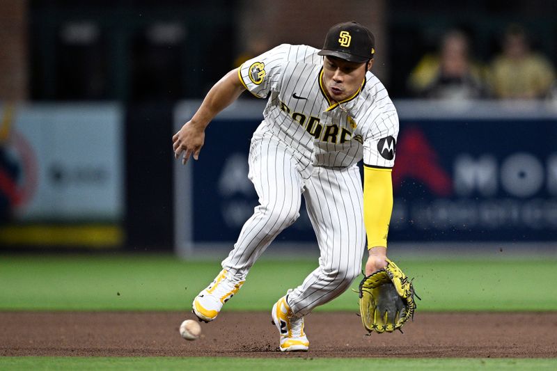 Apr 30, 2024; San Diego, California, USA; San Diego Padres shortstop Ha-Seong Kim (7) fields a ground ball during the fifth inning against the Cincinnati Reds at Petco Park. Mandatory Credit: Orlando Ramirez-USA TODAY Sports