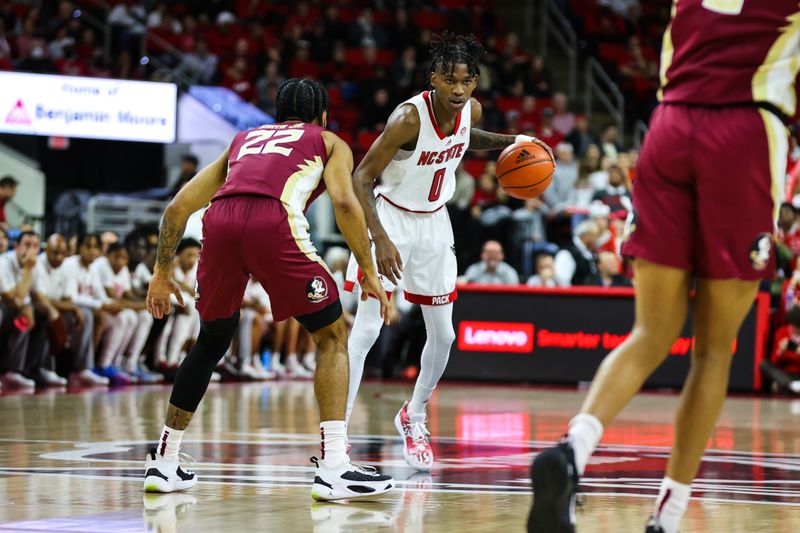 Feb 1, 2023; Raleigh, North Carolina, USA; North Carolina State Wolfpack guard Terquavion Smith (0) controls the ball against Florida State Seminoles guard Darin Green Jr. (22) during the first half at PNC Arena.  Mandatory Credit: Jaylynn Nash-USA TODAY Sports