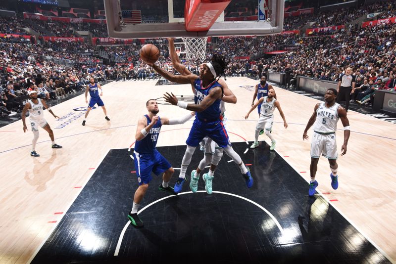 LOS ANGELES, CA - MARCH 12:  Terance Mann #14 of the LA Clippers drives to the basket during the game against the Minnesota Timberwolves on March 12, 2024 at Crypto.Com Arena in Los Angeles, California. NOTE TO USER: User expressly acknowledges and agrees that, by downloading and/or using this Photograph, user is consenting to the terms and conditions of the Getty Images License Agreement. Mandatory Copyright Notice: Copyright 2024 NBAE (Photo by Tyler Ross/NBAE via Getty Images)