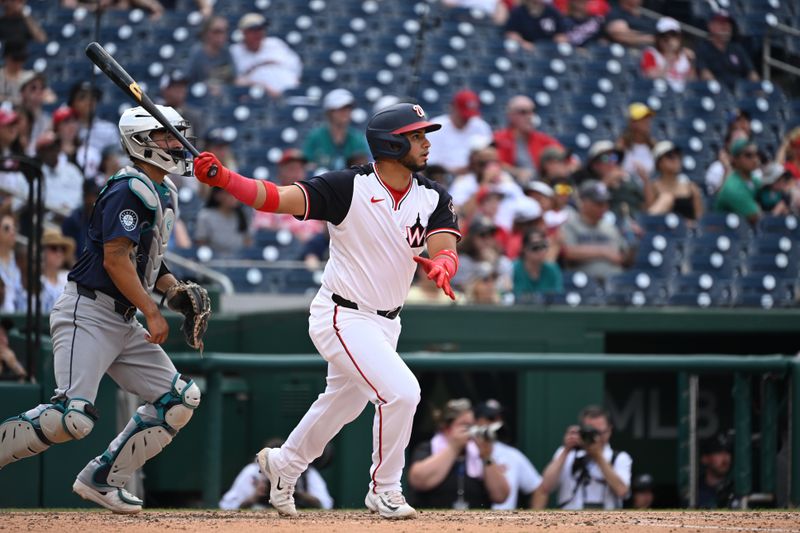 May 26, 2024; Washington, District of Columbia, USA; Washington Nationals catcher Keibert Ruiz (20) watches the ball after base hit against the Seattle Mariners during the seventh inning at Nationals Park. Mandatory Credit: Rafael Suanes-USA TODAY Sports