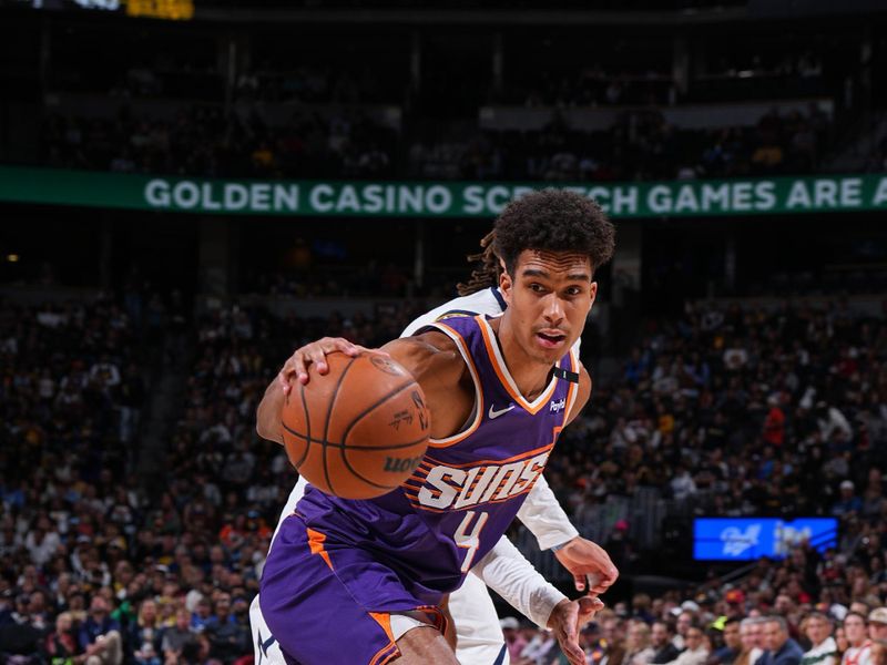 DENVER, CO - OCTOBER 13: Oso Ighodaro #4 of the Phoenix Suns dribbles the ball during the game against the Denver Nuggets on October 13, 2024 at Ball Arena in Denver, Colorado. NOTE TO USER: User expressly acknowledges and agrees that, by downloading and/or using this Photograph, user is consenting to the terms and conditions of the Getty Images License Agreement. Mandatory Copyright Notice: Copyright 2024 NBAE (Photo by Garrett Ellwood/NBAE via Getty Images)