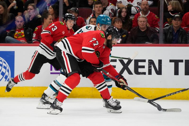 Oct 17, 2024; Chicago, Illinois, USA; San Jose Sharks center Alexander Wennberg (21) and Chicago Blackhawks left wing Patrick Maroon (77) go for the puck during the second period at United Center. Mandatory Credit: David Banks-Imagn Images