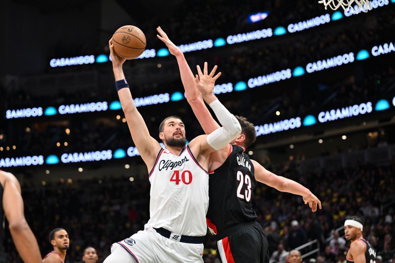 SEATTLE, WASHINGTON - OCTOBER 11: Ivica Zubac #40 of the LA Clippers shoots the ball against Donovan Clingan #23 of the Portland Trail Blazers during the second quarter of the Rain City Showcase game at Climate Pledge Arena on October 11, 2024 in Seattle, Washington. NOTE TO USER: User expressly acknowledges and agrees that, by downloading and or using this photograph, User is consenting to the terms and conditions of the Getty Images License Agreement. (Photo by Alika Jenner/Getty Images)