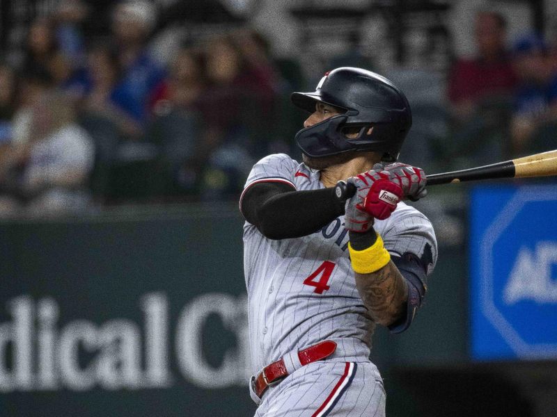 Sep 3, 2023; Arlington, Texas, USA; Minnesota Twins shortstop Carlos Correa (4) hits a single against the Texas Rangers during the fourth inning at Globe Life Field. Mandatory Credit: Jerome Miron-USA TODAY Sports