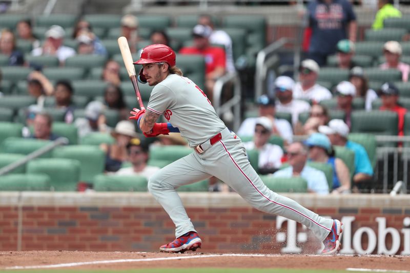 Jun 29, 2025; Cumberland, Georgia, Philadelphia Phillies second baseman Bryson Stott (5) hits a single during a game against the Atlanta Braves during the fifth inning at Truist Park. Mandatory Credit: Mady Mertens-Imagn Images
