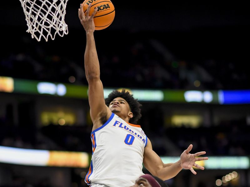 Mar 16, 2024; Nashville, TN, USA;  Florida Gators guard Zyon Pullin (0) lays the ball in against the Texas A&M Aggies during the second half at Bridgestone Arena. Mandatory Credit: Steve Roberts-USA TODAY Sports