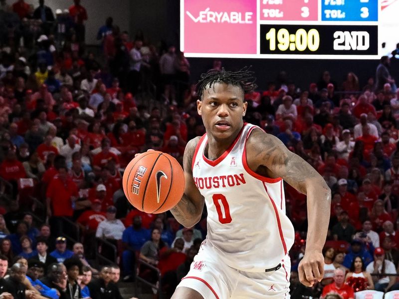 Feb 19, 2023; Houston, Texas, USA; Houston Cougars guard Marcus Sasser (0) drives to the basket around Memphis Tigers guard Elijah McCadden (0) during the second half at Fertitta Center. Mandatory Credit: Maria Lysaker-USA TODAY Sports