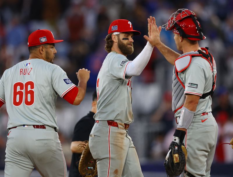 [US, Mexico & Canada customers only] June 8, 2024; London, UNITED KINGDOM;  Philadelphia Phillies players Bryce Harper, Jose Ruiz and J.T. Realmuto celebrate after defeating the New York Mets during a London Series baseball game at Queen Elizabeth Olympic Park. Mandatory Credit: Matthew Childs/Reuters via USA TODAY Sports