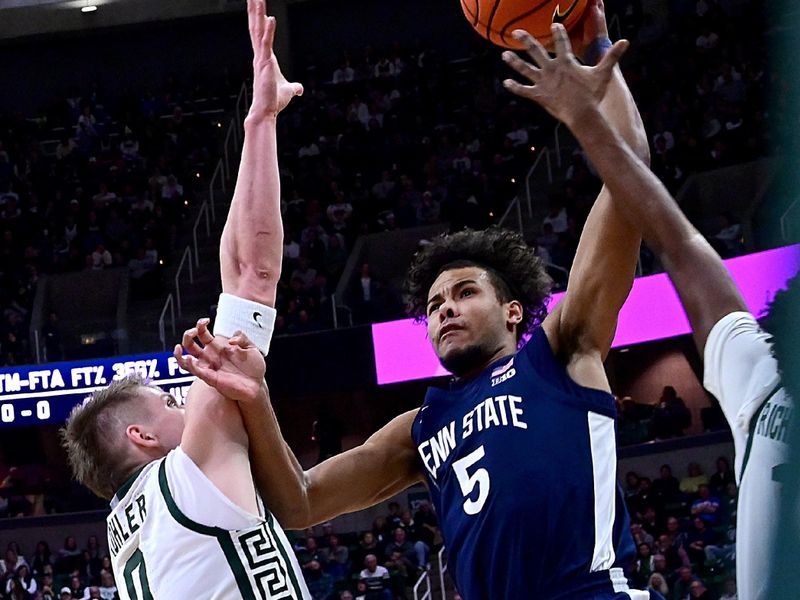 Jan 15, 2025; East Lansing, Michigan, USA;  Penn State Nittany Lions guard Puff Johnson (5) can’t  get a shot off against the Michigan State Spartans defense during the first half at Jack Breslin Student Events Center. Mandatory Credit: Dale Young-Imagn Images