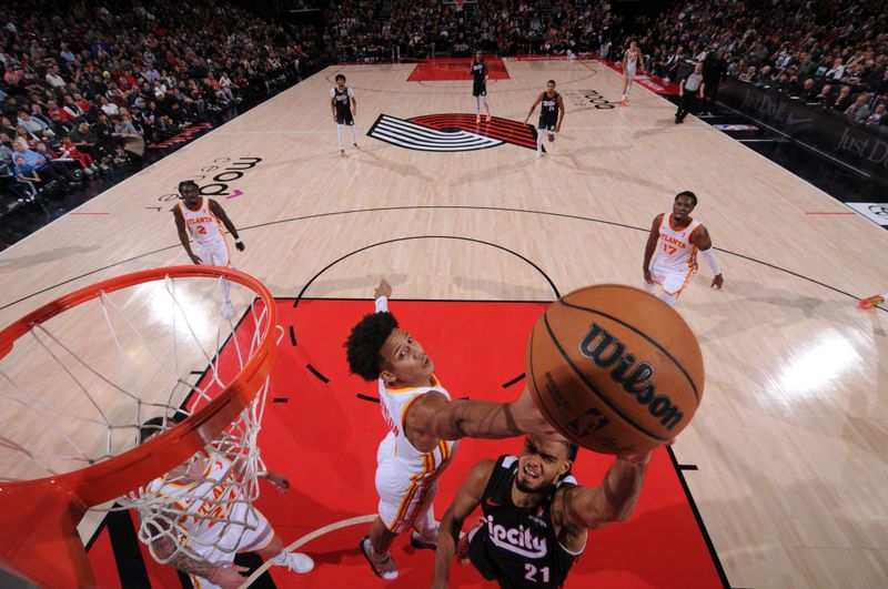 PORTLAND, OR - November 17:  Jalen Johnson #1 of the Atlanta Hawks attempts a block on Rayan Rupert #21 of the Portland Trail Blazers on November 17, 2024 at the Moda Center Arena in Portland, Oregon. NOTE TO USER: User expressly acknowledges and agrees that, by downloading and or using this photograph, user is consenting to the terms and conditions of the Getty Images License Agreement. Mandatory Copyright Notice: Copyright 2024 NBAE (Photo by Cameron Browne/NBAE via Getty Images)