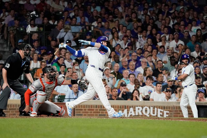 Jun 18, 2024; Chicago, Illinois, USA; Chicago Cubs outfielder Ian Happ (8) hits a one run single against the San Francisco Giants during the eighth inning at Wrigley Field. Mandatory Credit: David Banks-USA TODAY Sports