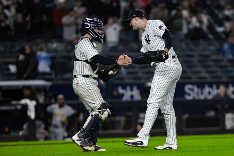 Sep 29, 2024; Bronx, New York, USA; New York Yankees catcher Jose Trevino (39) and New York Yankees pitcher Clay Holmes (35) slap hands after the games final out against the Pittsburgh Pirates at Yankee Stadium. Mandatory Credit: John Jones-Imagn Images