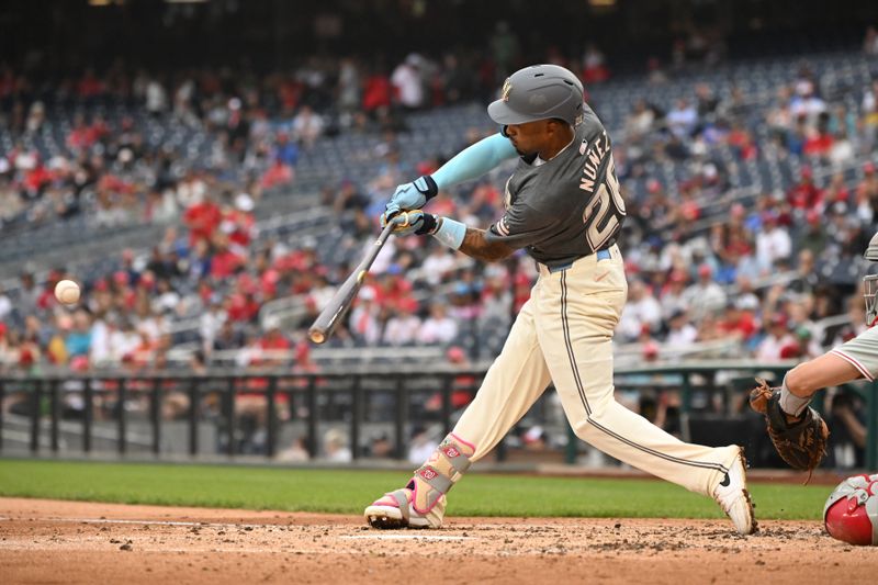 Sep 29, 2024; Washington, District of Columbia, USA; Washington Nationals shortstop Nasim Nunez (26) hits the ball into play against the Philadelphia Phillies during the third inning at Nationals Park. Mandatory Credit: Rafael Suanes-Imagn Images