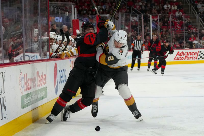 Mar 11, 2023; Raleigh, North Carolina, USA;  Vegas Golden Knights defenseman Zach Whitecloud (2) and Carolina Hurricanes right wing Jesper Fast (71) battle over the puck during the third period at PNC Arena. Mandatory Credit: James Guillory-USA TODAY Sports