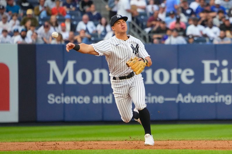 Jun 22, 2023; Bronx, New York, USA; New York Yankees shortstop Anthony Volpe (11) throws out Seattle Mariners center fielder Julio Rodriguez (not pictured) after fielding a ground ball during the second inning at Yankee Stadium. Mandatory Credit: Gregory Fisher-USA TODAY Sports