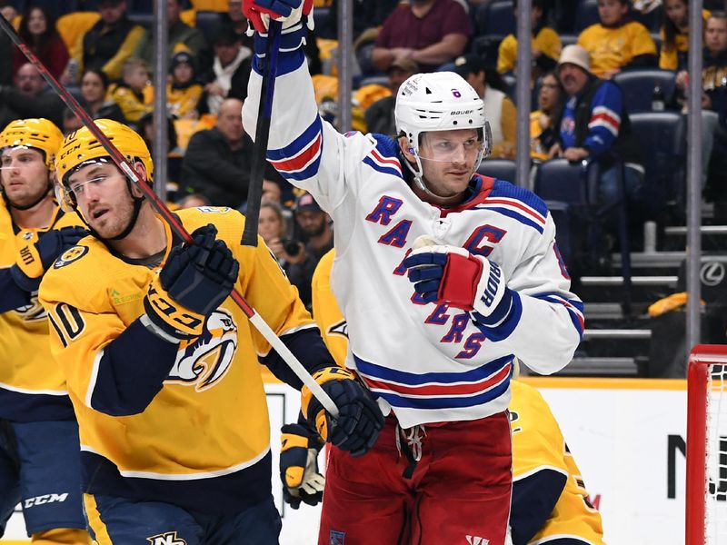 Dec 2, 2023; Nashville, Tennessee, USA; New York Rangers defenseman Jacob Trouba (8) celebrates after a goal against Nashville Predators goaltender Kevin Lankinen (32) during the second period at Bridgestone Arena. Mandatory Credit: Christopher Hanewinckel-USA TODAY Sports