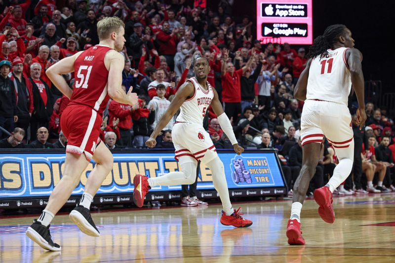 Jan 17, 2024; Piscataway, New Jersey, USA; Rutgers Scarlet Knights forward Aundre Hyatt (5) reacts in front of Nebraska Cornhuskers forward Rienk Mast (51) and center Clifford Omoruyi (11) after making a three point basket during overtime against the Nebraska Cornhuskers at Jersey Mike's Arena. Mandatory Credit: Vincent Carchietta-USA TODAY Sports