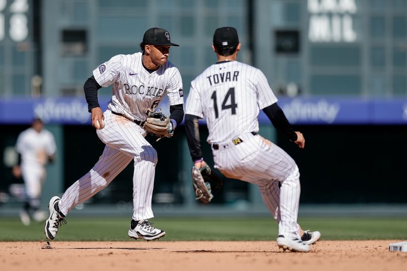 Sep 18, 2025; Denver, Colorado, USA; Colorado Rockies second baseman Ryan Ritter (8) runs to second for an out ahead of shortstop Ezequiel Tovar (14) in the eighth inning against the Miami Marlins at Coors Field. Mandatory Credit: Isaiah J. Downing-Imagn Images