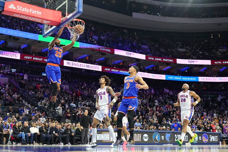 PHILADELPHIA, PENNSYLVANIA - JANUARY 15: Mikal Bridges #25 of the New York Knicks dunks the ball past Kelly Oubre Jr. #9 and Guerschon Yabusele #28 of the Philadelphia 76ers in overtime at the Wells Fargo Center on January 15, 2025 in Philadelphia, Pennsylvania. The Knicks defeated the 76ers 125-119 in overtime. NOTE TO USER: User expressly acknowledges and agrees that, by downloading and/or using this photograph, user is consenting to the terms and conditions of the Getty Images License Agreement. (Photo by Mitchell Leff/Getty Images)