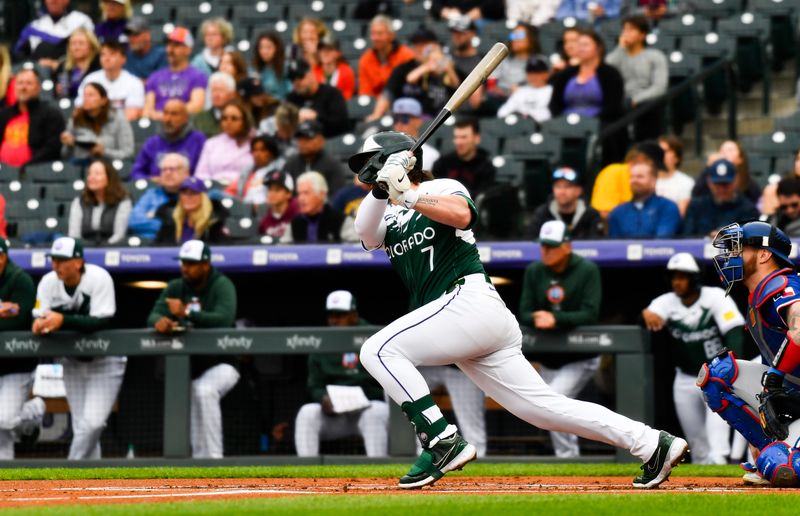 May 11, 2024; Denver, Colorado, USA; Colorado Rockies second base Brendan Rodgers (7) hits a single against the Texas Rangers during the first inning at Coors Field. Mandatory Credit: John Leyba-USA TODAY Sports