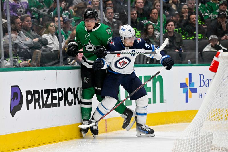 Feb 29, 2024; Dallas, Texas, USA; Winnipeg Jets center Mark Scheifele (55) checks Dallas Stars center Roope Hintz (24) during the second period at the American Airlines Center. Mandatory Credit: Jerome Miron-USA TODAY Sports