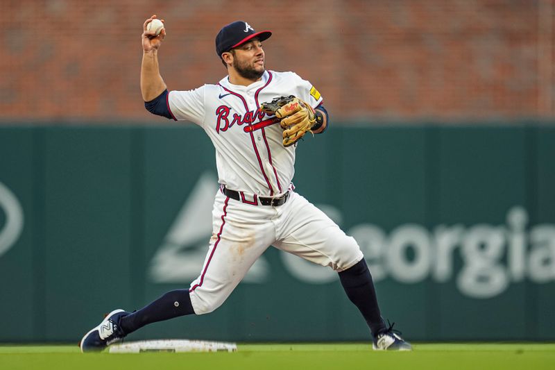 Apr 23, 2024; Cumberland, Georgia, USA; Atlanta Braves second base David Fletcher (22) throws for a double play against the Miami Marlins during the third inning at Truist Park. Mandatory Credit: Dale Zanine-USA TODAY Sports