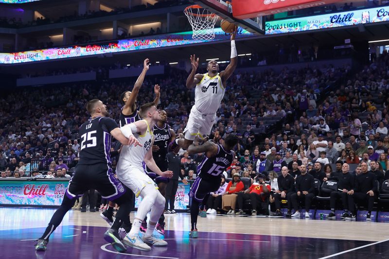 SACRAMENTO, CALIFORNIA - MARCH 31: Kris Dunn #11 of the Utah Jazz is fouled by Davion Mitchell #15 of the Sacramento Kings on his way to the basket in the first quarter at Golden 1 Center on March 31, 2024 in Sacramento, California. NOTE TO USER: User expressly acknowledges and agrees that, by downloading and or using this photograph, User is consenting to the terms and conditions of the Getty Images License Agreement. (Photo by Lachlan Cunningham/Getty Images)