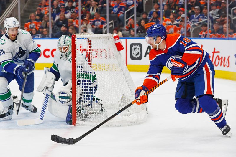 Apr 13, 2024; Edmonton, Alberta, CAN; Edmonton Oilers forward Zach Hyman (18) looks to make a pass from behind Vancouver Canucks goaltender Casey DeSmith (29) during the third period at Rogers Place. Mandatory Credit: Perry Nelson-USA TODAY Sports