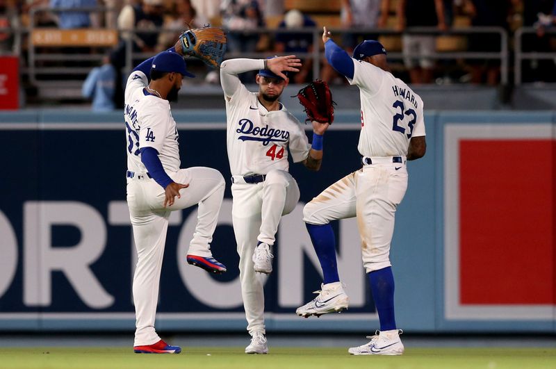 Jul 23, 2024; Los Angeles, California, USA; Los Angeles Dodgers outfielder Teoscar Hernandez (37), outfielder Andy Pages (44) and outfielder Jason Heyward (23) celebrate after defeating the San Francisco Giants at Dodger Stadium. Mandatory Credit: Jason Parkhurst-USA TODAY Sports