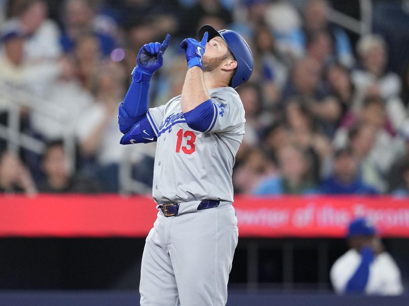 Apr 26, 2024; Toronto, Ontario, CAN; Los Angeles Dodgers third base Max Muncy (13) celebrates hitting a three-run home run against the Toronto Blue Jays during the third inning at Rogers Centre. Mandatory Credit: Nick Turchiaro-USA TODAY Sports