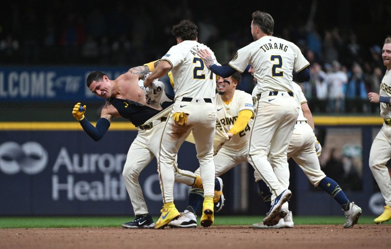 Apr 26, 2024; Milwaukee, Wisconsin, USA; Milwaukee Brewers third base Joey Ortiz (3) is chased after and his jersey ripped off by Milwaukee Brewers shortstop Willy Adames (27) after driving in the winning run against the New York Yankees in the eleventh inning at American Family Field. Milwaukee Brewers 7, New York Yankees 6 in eleven inning. Mandatory Credit: Michael McLoone-USA TODAY Sports