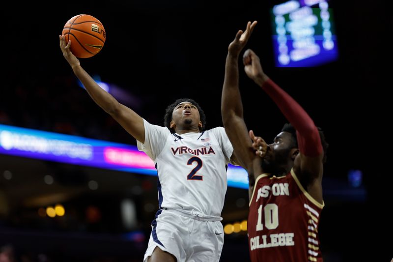 Jan 28, 2023; Charlottesville, Virginia, USA; Virginia Cavaliers guard Reece Beekman (2) shoots the ball as Boston College Eagles guard Prince Aligbe (10) defends in the second half at John Paul Jones Arena. Mandatory Credit: Geoff Burke-USA TODAY Sports
