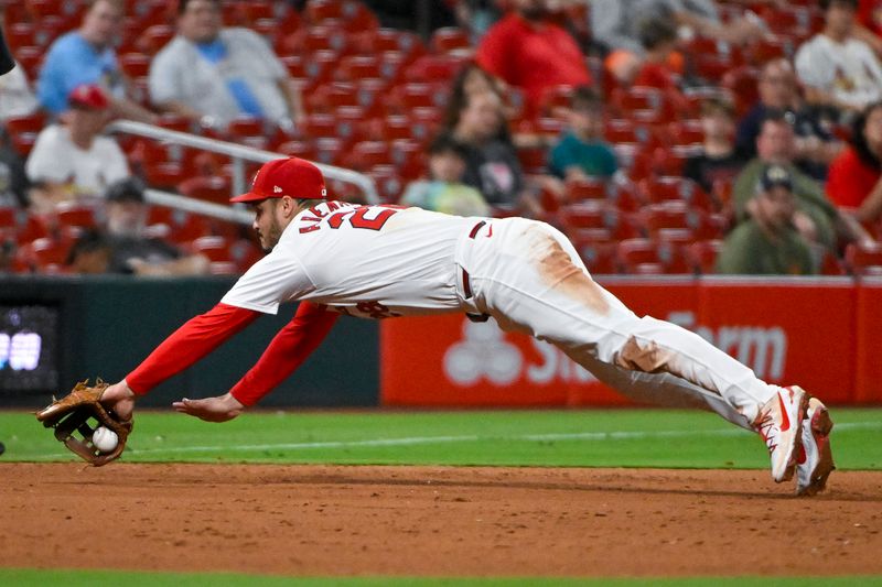 Sep 18, 2024; St. Louis, Missouri, USA;  St. Louis Cardinals third baseman Nolan Arenado (28) dives but is unable to field a ground ball hit by Pittsburgh Pirates center fielder Billy Cook (not pictured) during the ninth inning at Busch Stadium. Mandatory Credit: Jeff Curry-Imagn Images