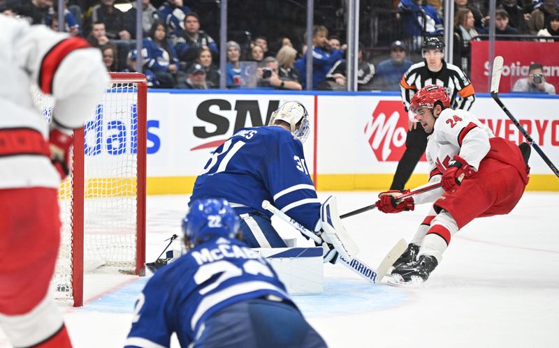 Dec 30, 2023; Toronto, Ontario, CAN; Carolina Hurricanes forward Seth Jarvis (24) scores a goal past Toronto Maple Leafs goalie Martin Jones  (31) in the second period at Scotiabank Arena. Mandatory Credit: Dan Hamilton-USA TODAY Sports