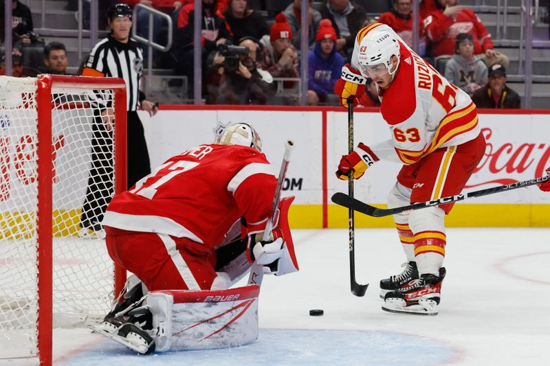 Oct 22, 2023; Detroit, Michigan, USA;  Detroit Red Wings goaltender James Reimer (47) makes the save on Calgary Flames center Adam Ruzicka (63) in the third period at Little Caesars Arena. Mandatory Credit: Rick Osentoski-USA TODAY Sports